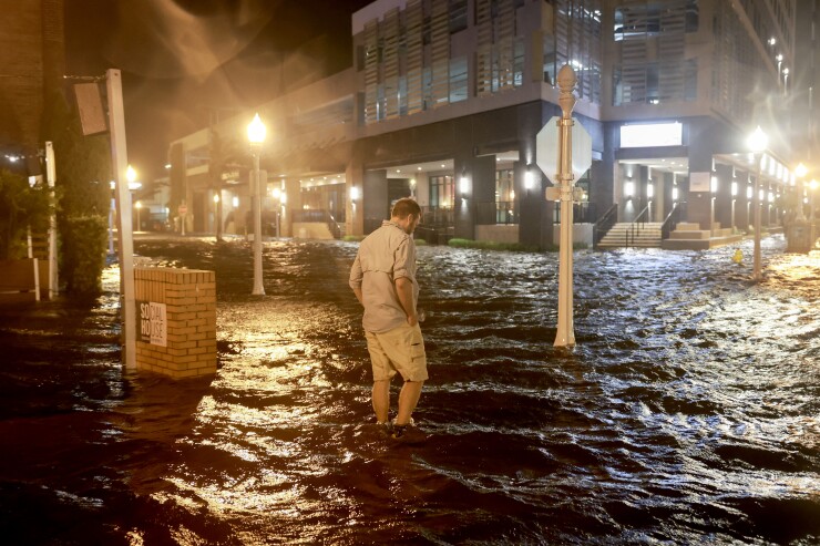 Surge waters flood a street in the Sarasota area in Fort Myers.