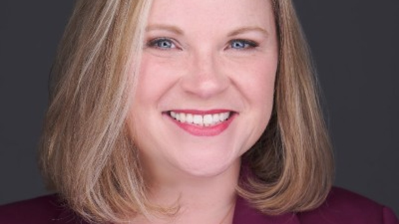 A woman smiling for a photo.