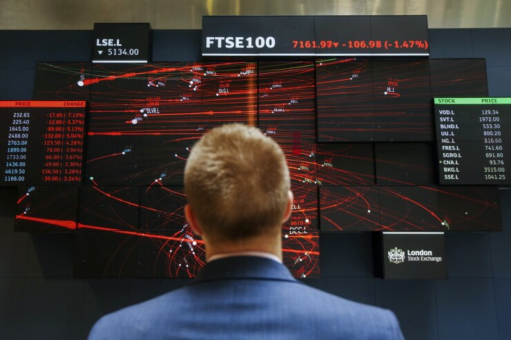 An employee views a FTSE 100 share index board in the atrium of the London Stock Exchange Group Plc's offices in London, U.K., on Wednesday, May 29, 2019. While the FTSE 100 Index has climbed about 15 percent since June 2016 in local currency, it's down in both euro and dollar terms. Photographer: Luke MacGregor/Bloomberg