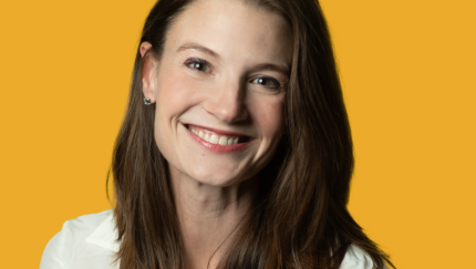 A woman smiling for a photo.