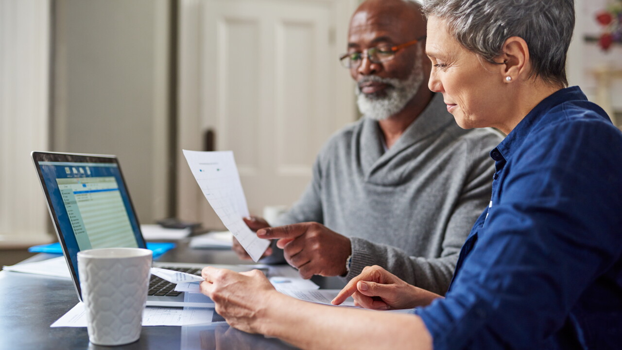 Laptop, documents and finance with a senior couple busy on a budget review in the home together. Accounting, taxes or investment planning with a mature man and woman looking at insurance or savings.