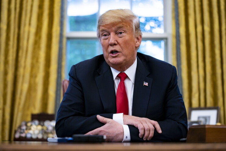 President Donald Trump speaks during an interview in the Oval Office.