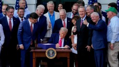 President Donald Trump signs the One Big Beautiful Bill Act on the South Lawn of the White House in Washington on July 4.