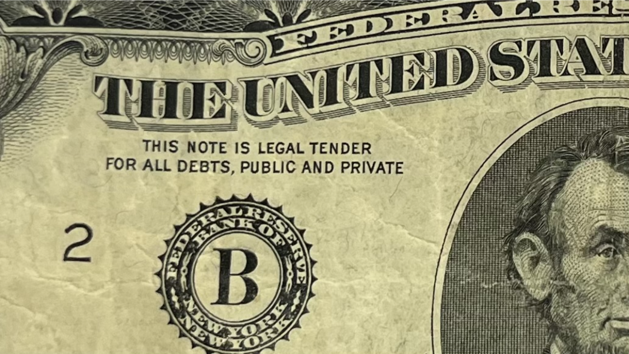 A close-up picture of a $5 bill.