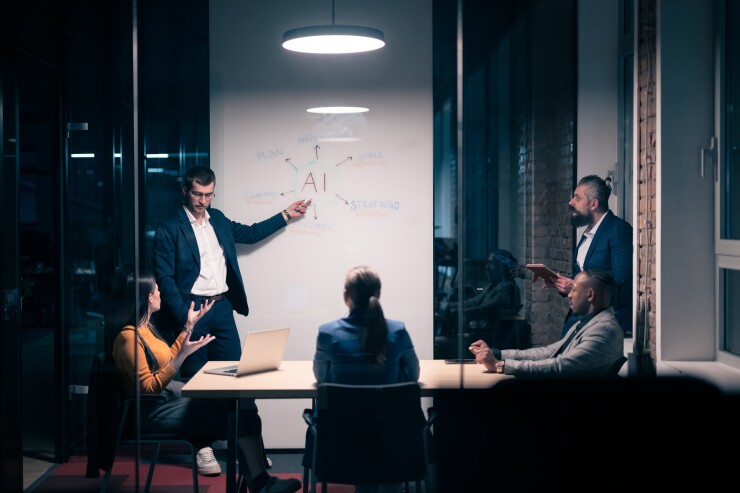 Diverse business team in modern office discussing AI with whiteboard.