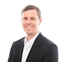 A man smiling for a portrait photo.