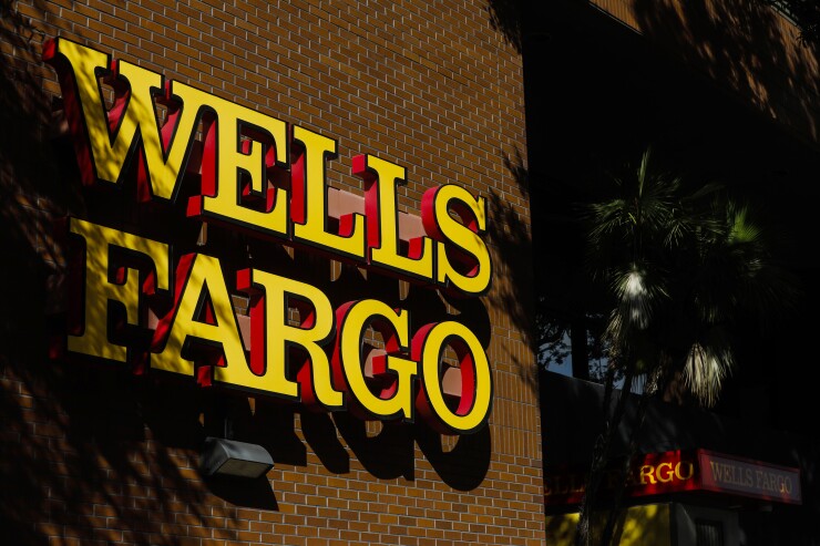 Signage is displayed outside of a Wells Fargo bank branch in St. Petersburg, Florida.