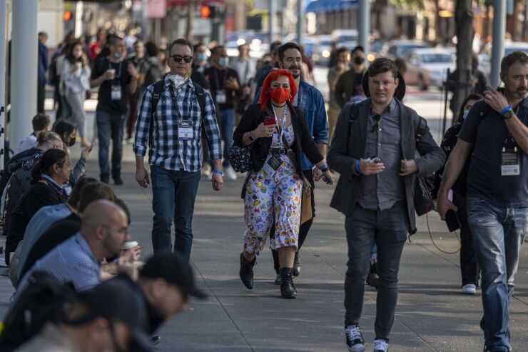 Attendees outside an exhibition hall during the Game Developers Conference at the Moscone Center in San Francisco, California, U.S., on Tuesday, March 22, 2022. The weeklong video game industry conference is San Francisco's biggest convention since public health orders upended the events business two years ago, reported the San Francisco Chronicle. Photographer: David Paul Morris/Bloomberg