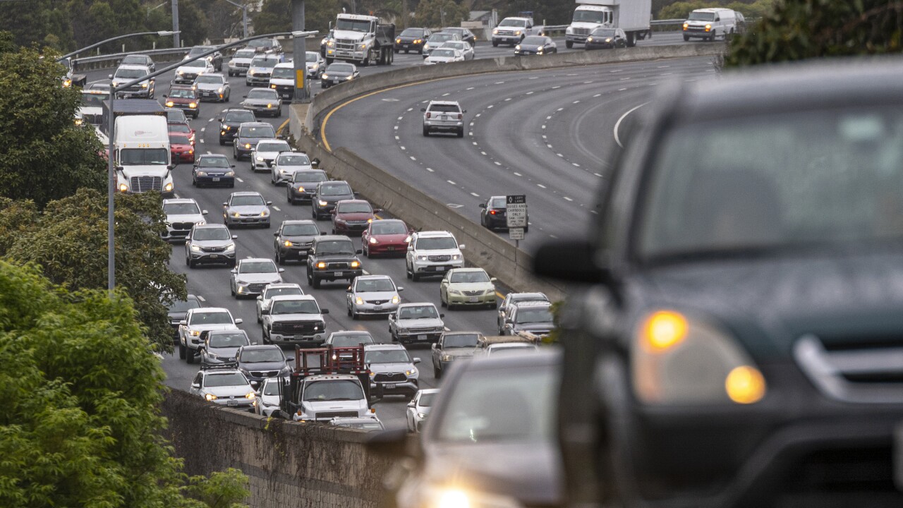 Cars on a road with five lanes of traffic.