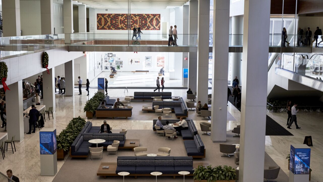 People sit in the Town Square meeting area at the new Citigroup headquarters in New York on Dec. 3, 2019.