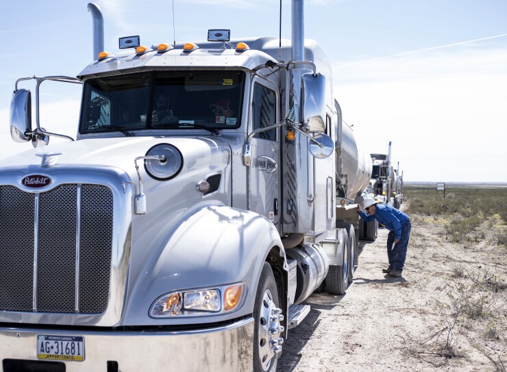Driver inspects 18-wheeler truck