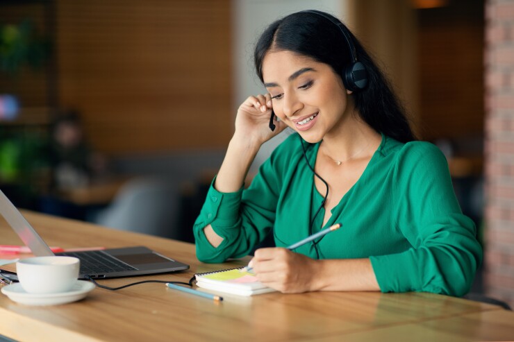 Woman writing notes.