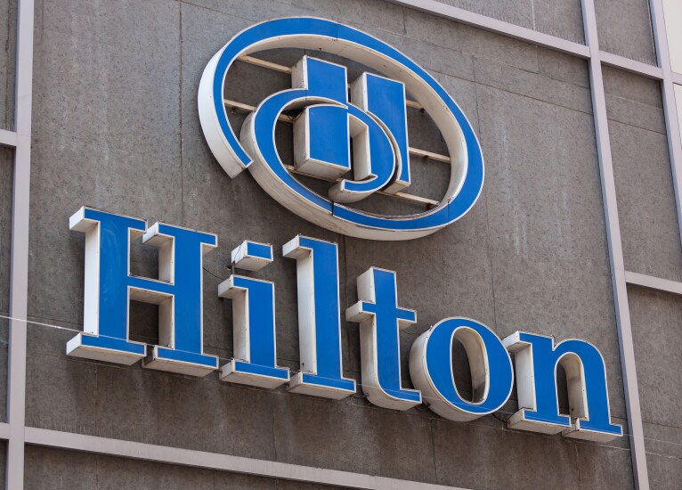 The words "Hilton" in blue on a gray building.