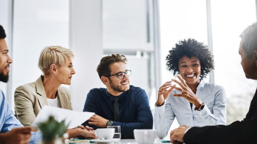 Group of employees talking at table