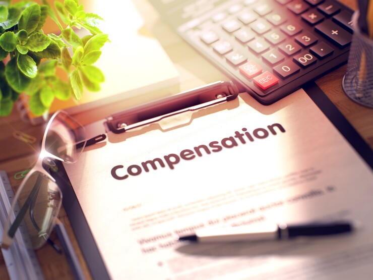 A paper with words at top that read: "Compensation."
