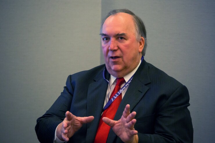 John Engler, then president of Business Roundtable, right, speaks in New York, U.S., on Tuesday, Oct. 25, 2016. The former Michigan governor was named interim president of Michigan State University in 2018.