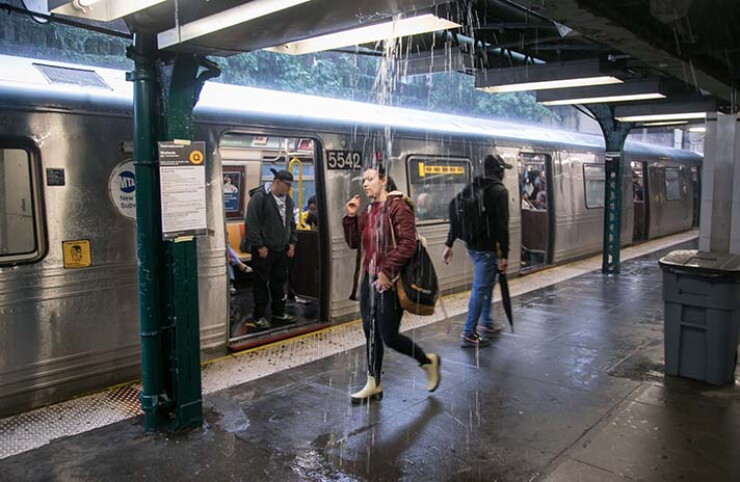Rain leaks from the ceiling of a subway station during a rainstorm in Brooklyn Friday