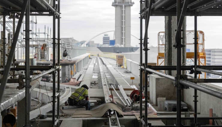 Worker installing track switch on LAX's People Mover train's elevated guideway in December