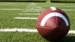 A football on a field.