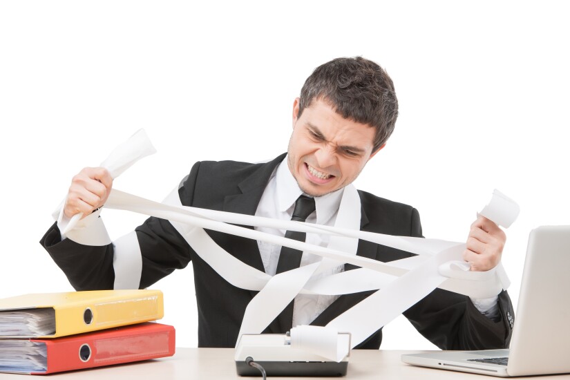 Man fighting with calculator tape