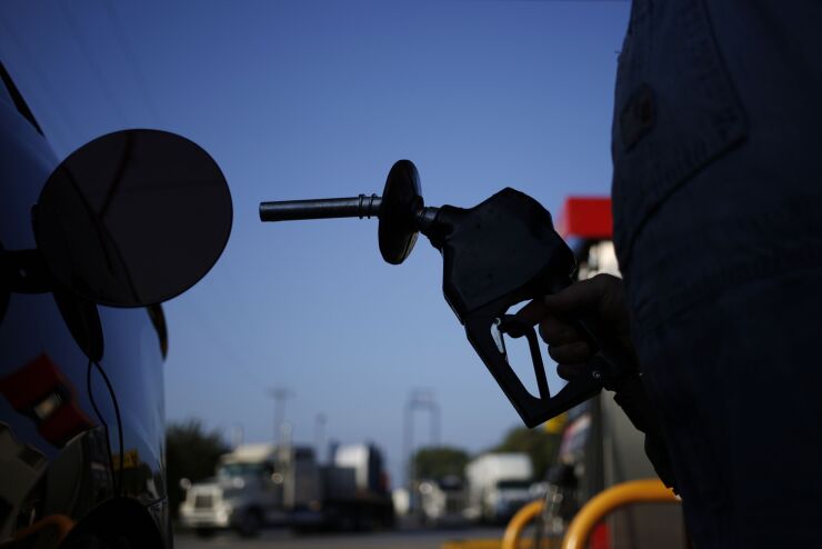 A motorist fills his vehicle with gasoline at a Pilot Travel Center gas station in Cornersville, Tennessee.