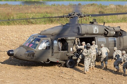 GRAVE, NETHERLANDS - SEP 17: Soldiers of the 82nd Airborne Division enter a Black Hawk helicopter at the Operation Market Garden memorial on Sep 17, 2014 Grave, Netherlands. Market Garden was a large Allied operation in 1944.