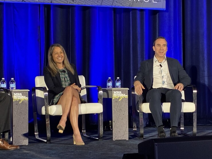 Jeana Curro of Bank of America Securities and John Sim of J.P. Morgan speak at the Mortgage Bankers Association's Secondary and Capital Markets Conference in New York on May 18.