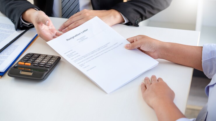 Woman handing in a resignation letter