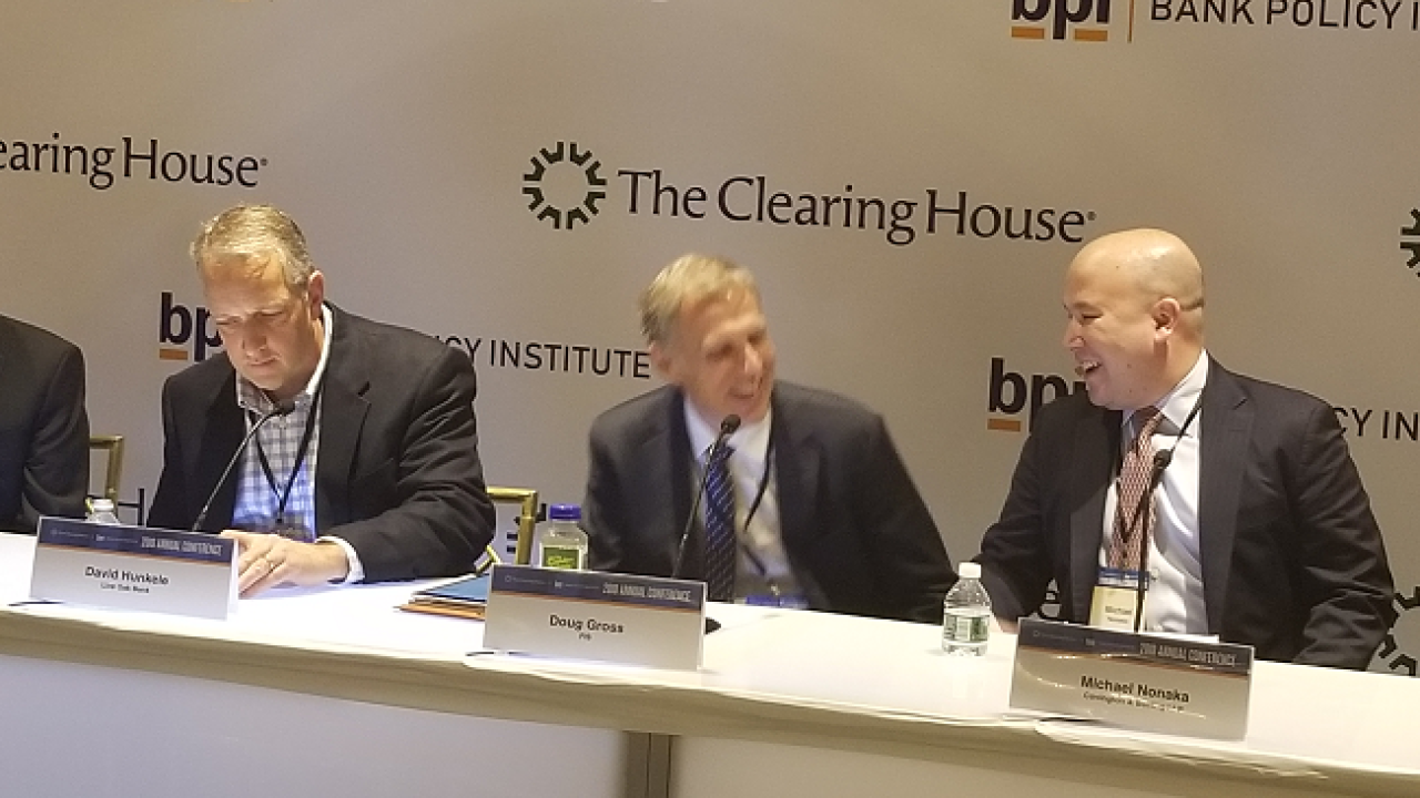 Doug Gross, Division Executive, Corporate Banking Solutions, FIS and Michael Nonaka, Partner, Covington & Burling, share a laugh.