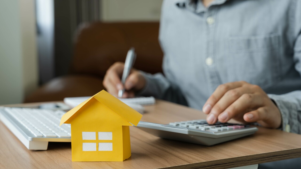 Business Finance concept. Close up yellow paper house model wit