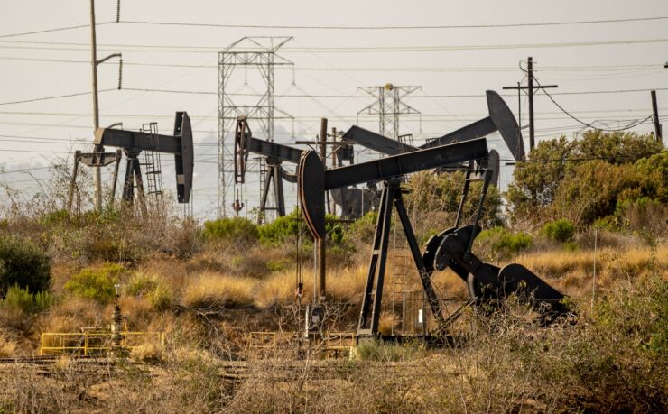 Oil pump jacks operate at the Inglewood Oil Field in Culver City, California, U.S., on Sunday, July 11, 2021. Oil dipped after a two-day gain as investors assessed the demand outlook amid a resurgence of Covid-19 in many regions. Photographer: Kyle Grillot/Bloomberg