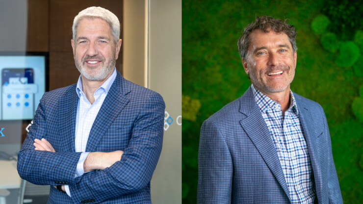 Side-by-side headshots of two smiling businessmen wearing blue patterned blazers.