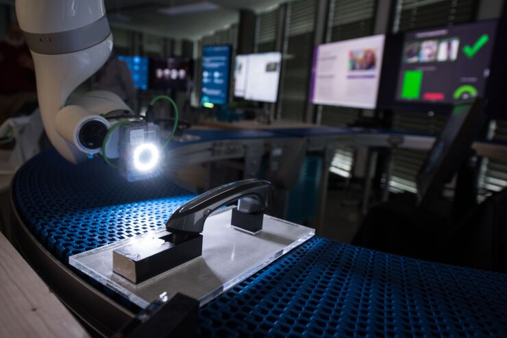 An IBM Visual Inspection system illuminates an automobile door handle at the International Business Machines Corp. (IBM) Watson cognitive computing platform IoT center in Munich, Germany, on Thursday, Aug. 10, 2017. IBM is revamping its Global Technology Services division, which helps customers run their computer networks, to rely more heavily on artificial intelligence. Photographer: Andreas Arnold/Bloomberg