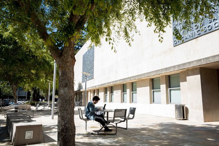 A person works on a laptop computer on the University of California, Berkeley campus in Berkeley, California, U.S., on Friday, June 4, 2021. The University of California has shared details on a proposed Covid-19 vaccination policy that would require students, faculty, academic appointees, and staff who are accessing campus facilities at any UC location beginning this fall to be immunized against SARS-CoV-2.