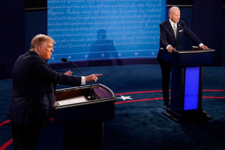 U.S. President Donald Trump, left, speaks as Joe Biden, 2020 Democratic presidential nominee, listens during the first U.S. presidential debate hosted by Case Western Reserve University and the Cleveland Clinic in Cleveland, Ohio, U.S. 