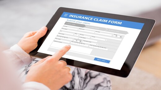 Person filing a claim on a tablet.