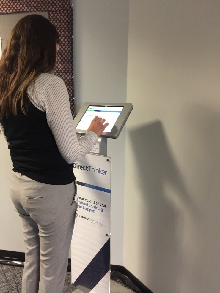 A Direct Federal Credit Union employee using the DirectThinker app at a kiosk.