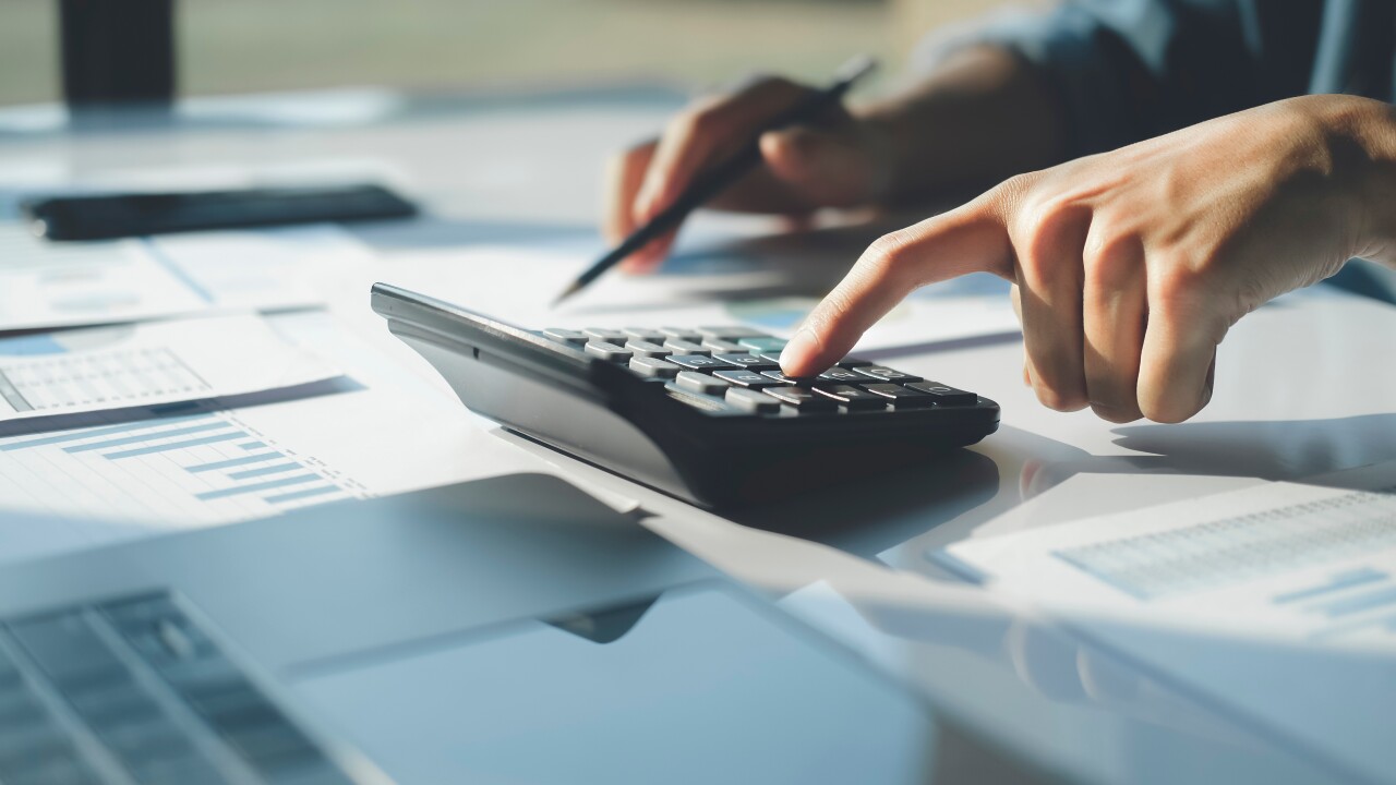 Accountant using calculator for calculate finance report in offi