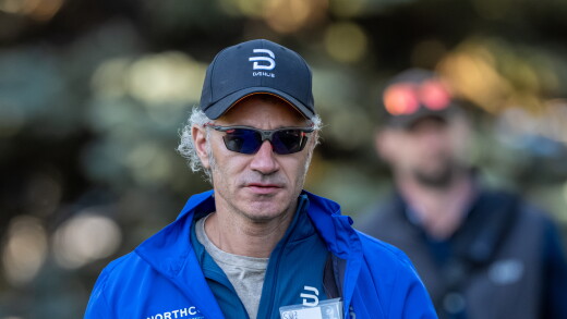 Alex Karp of Palantir walking outdoors.