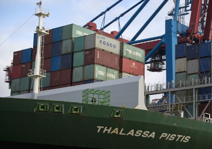 Shipping containers sit on the Thalassa Pistis container vessel docked at the Hamburger Hafen und Logistik AG Container Terminal Burchardkai in the Port of Hamburg in Hamburg, Germany.