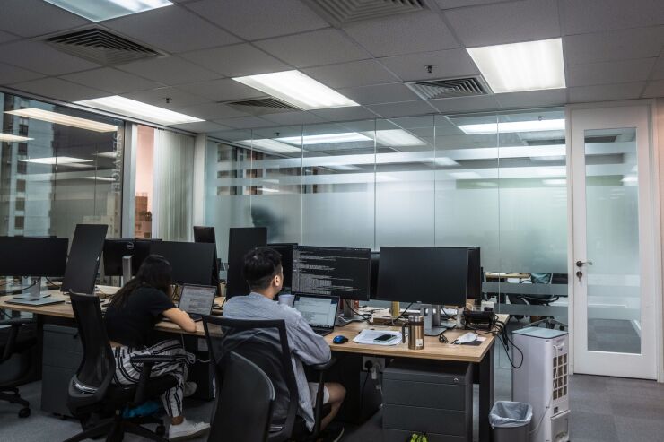 Employees work at the MioTech offices in Hong Kong, China, on Thursday, June 9, 2022. MioTech’s parent company, Cayman-based Mioying Holdings Inc., is in the process of raising about $150 million at a valuation of $1 billion, said co-founder and Chief Executive Officer Jason Tu. Photographer: Lam Yik/Bloomberg