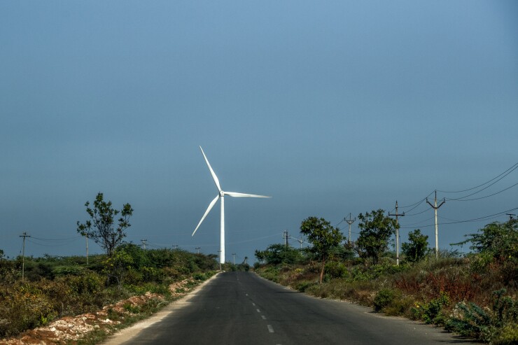 A wind turbine near a highway in India