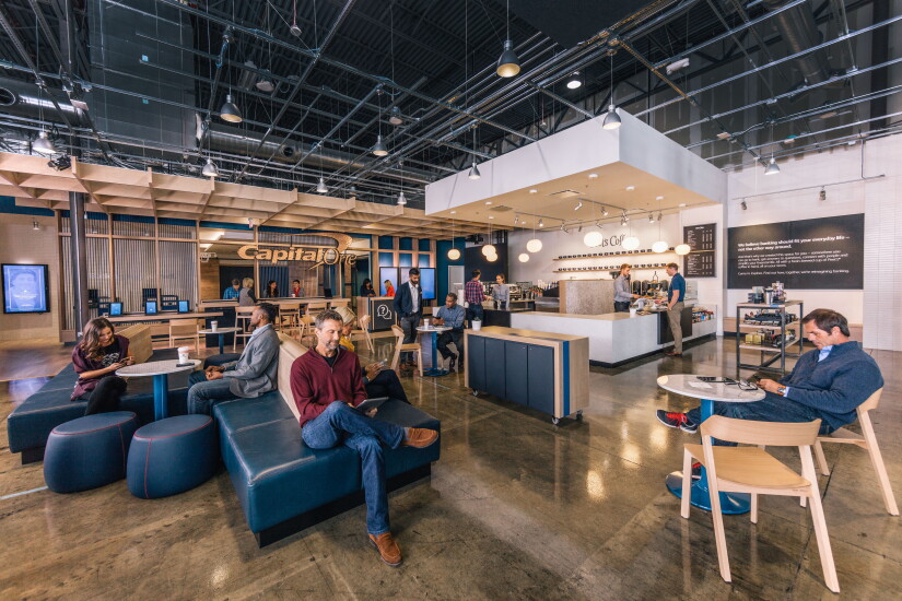 Customers browse mobile devices in a Capital One Cafe.