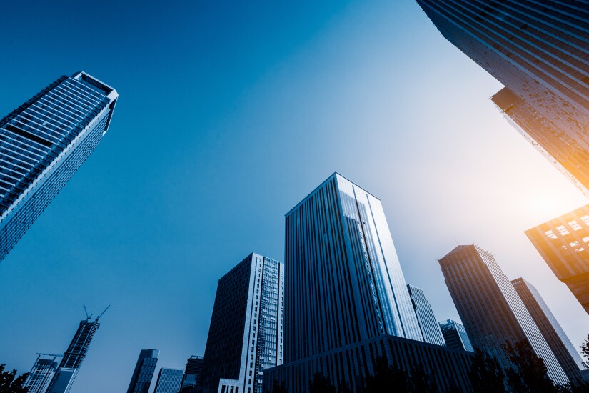 Several office buildings against blue sky.