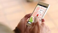 Person using a smartphone showing a GPS app