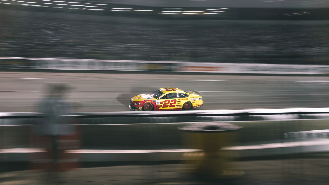 fast moving nascar cars during night race