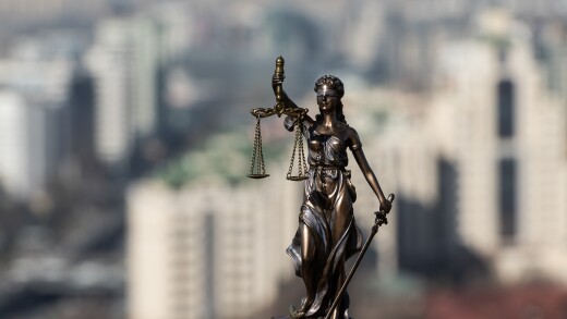 The figure of Themis against the backdrop of a modern city