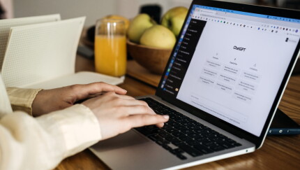 ChatGPT for content creators, ChatGPT help generate ideas and create content. Screen with ChatGPT AI or artificial intelligence chat and typing female hands. Warsaw, Poland - May 02, 2023