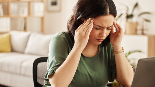 Woman holding temples, headache