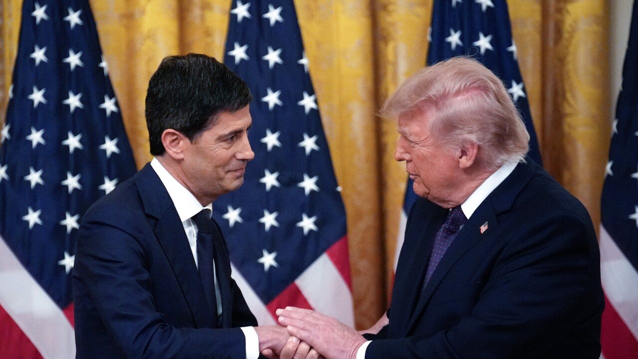 President Donald Trump and Kevin Warsh, chairman of the Federal Reserve, shake hands